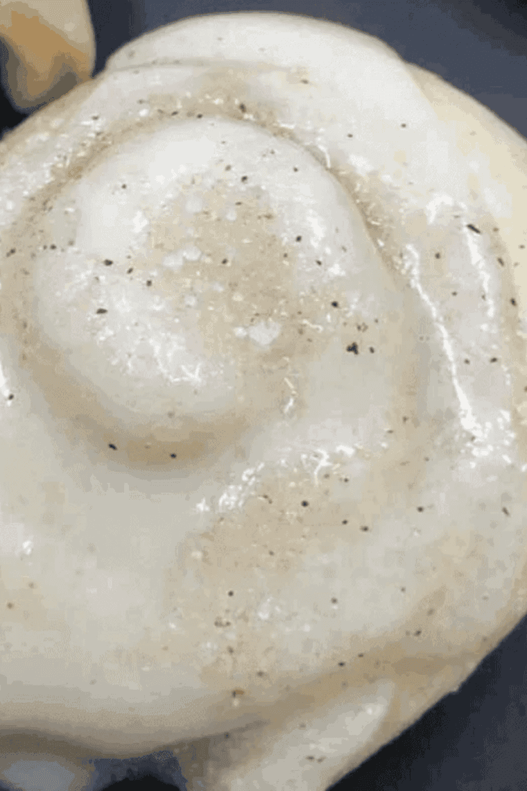 Cinnamon roll cookies placed in air fryer, being baked, then drizzled with icing and sprinkled with cinnamon sugar.