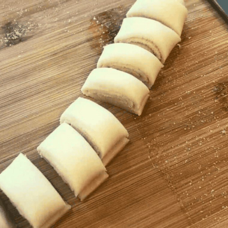 Brushing melted butter on dough, sprinkling cinnamon sugar, rolling, and slicing into &frac12;-inch pieces.