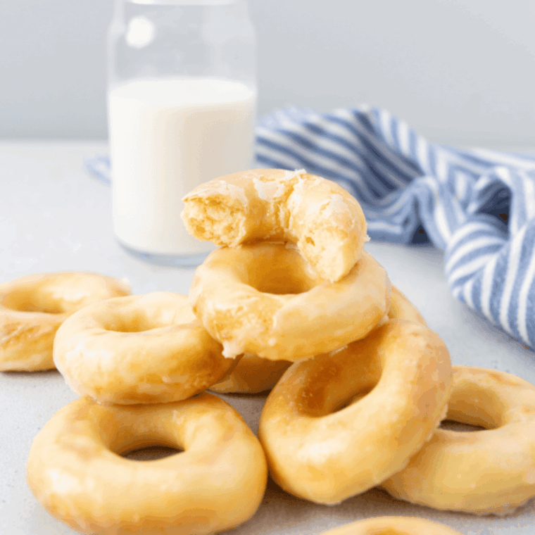 Homemade Dunkin Donuts glazed donuts copycat recipe with sweet shiny glaze.