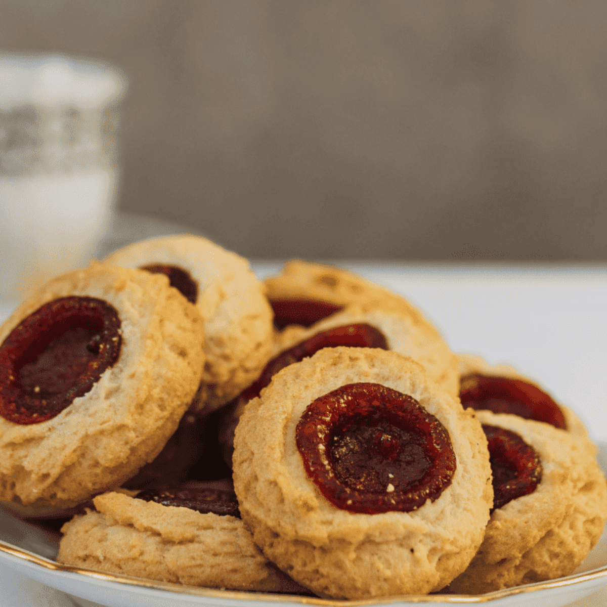 Freshly baked thumbprint cookies in an air fryer, soft and golden with jam-filled centers.