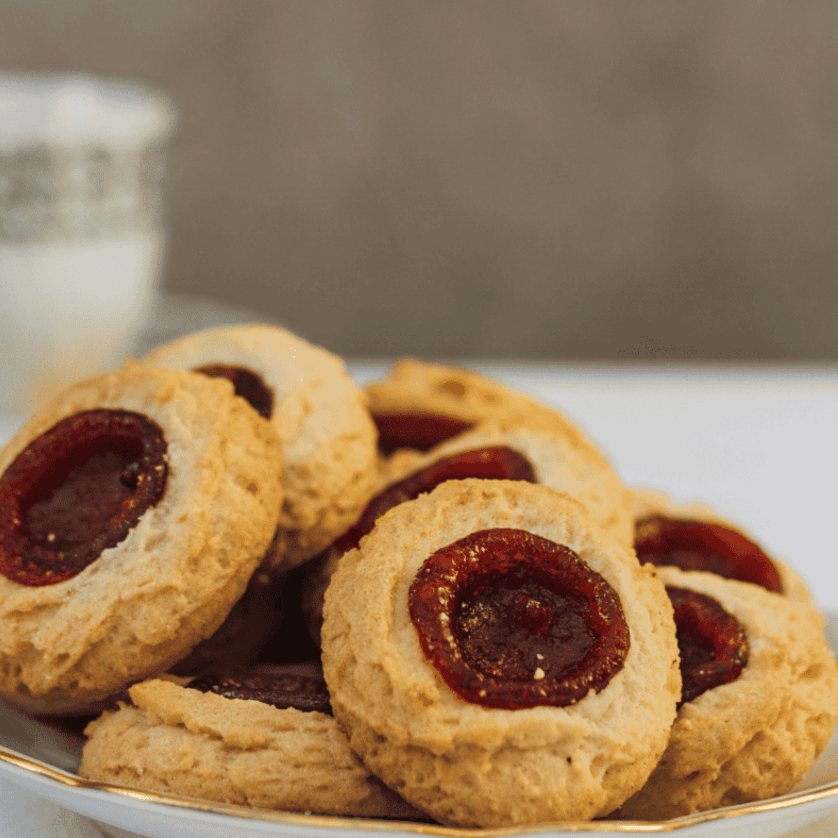 Freshly baked thumbprint cookies in an air fryer, golden and soft with jam-filled centers.