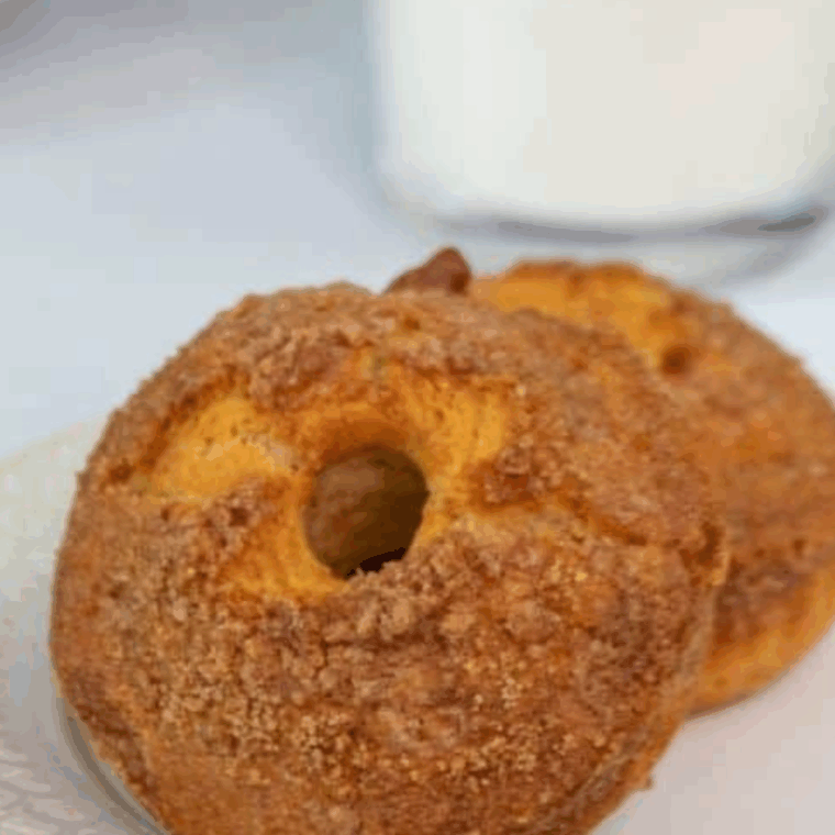 Air fryer cinnamon crumb donuts, golden and fluffy, topped with buttery cinnamon crumbs.
