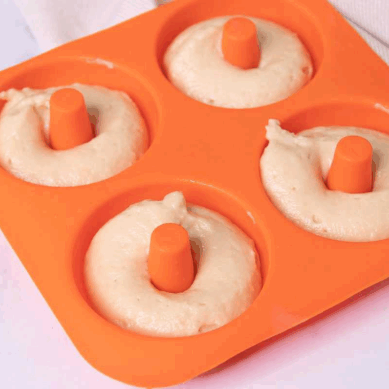 Donut pan greased with olive oil spray and filled two-thirds full with donut batter.