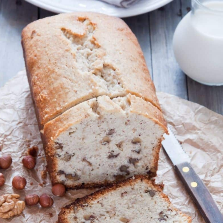 Slice of Air Fryer Cinnamon Walnut Pound Cake on a plate showing moist texture and crunchy cinnamon walnuts on top