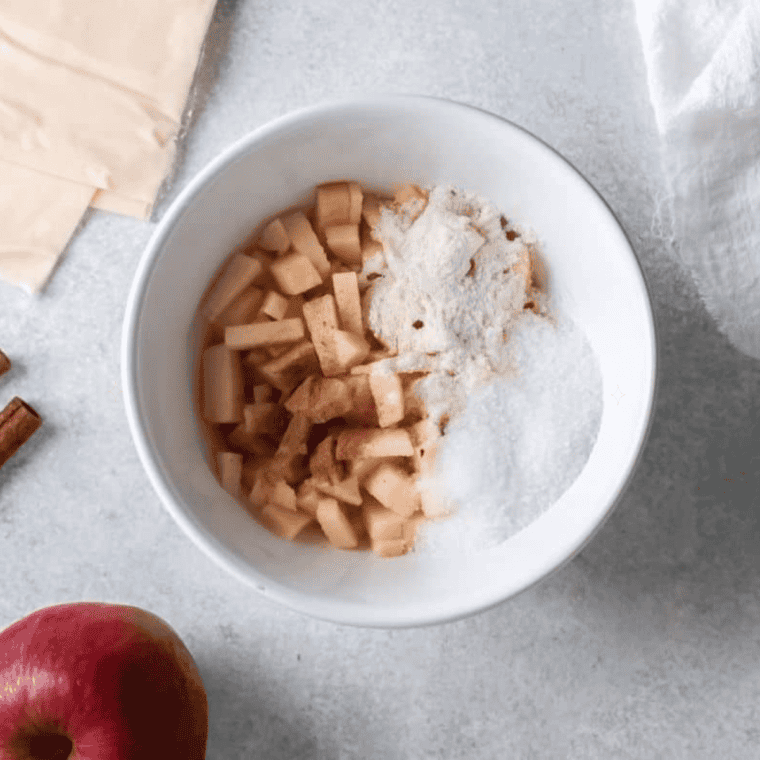 Diced Granny Smith apples cooking with brown sugar and cinnamon in a saucepan for air fryer copycat McDonald's apple pie filling