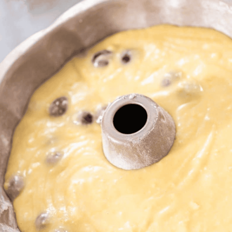 Prepare Pan and Pour Batter: Generously spray a bundt or loaf pan with olive oil or cooking spray, then pour the prepared batter evenly into the pan, ready for air frying.