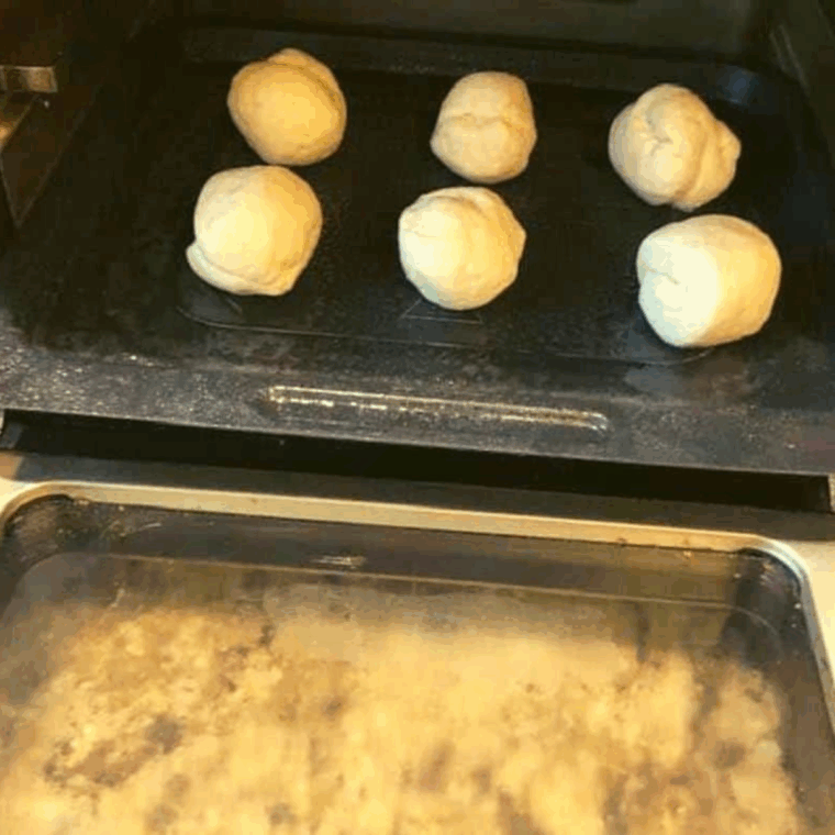 Place the donut holes into the air fryer.