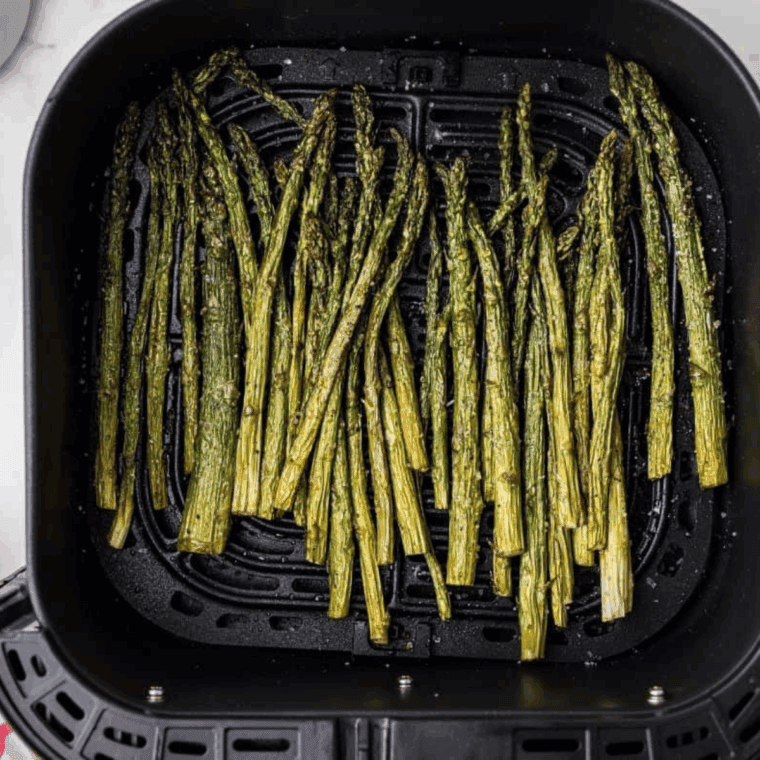 Cooked Chili&rsquo;s Asparagus Recipe in the air fryer basket.