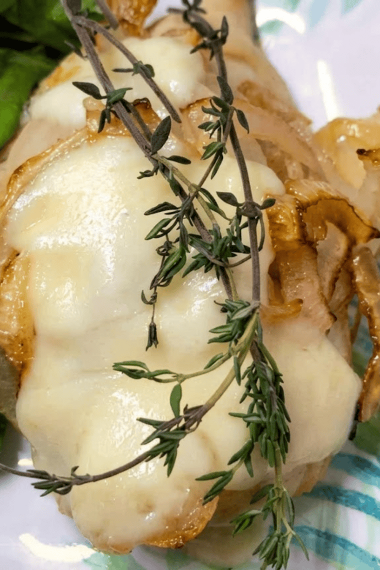 Finished French onion chicken with Fontina cheese melted over caramel-colored onions in the air fryer
