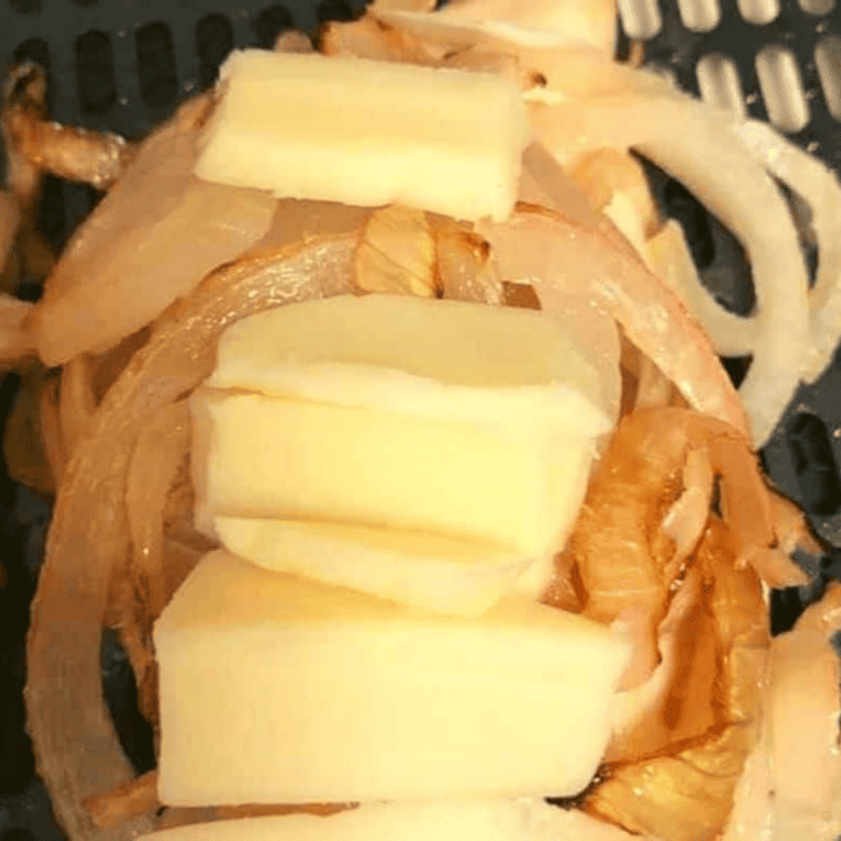 Air fried chicken breasts topped with golden roasted onions before adding cheese