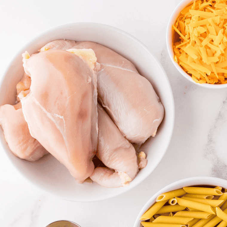 Ingredients for air fryer French onion chicken: chicken breasts, onion, olive oil, sugar, salt, pepper, and Fontina cheese