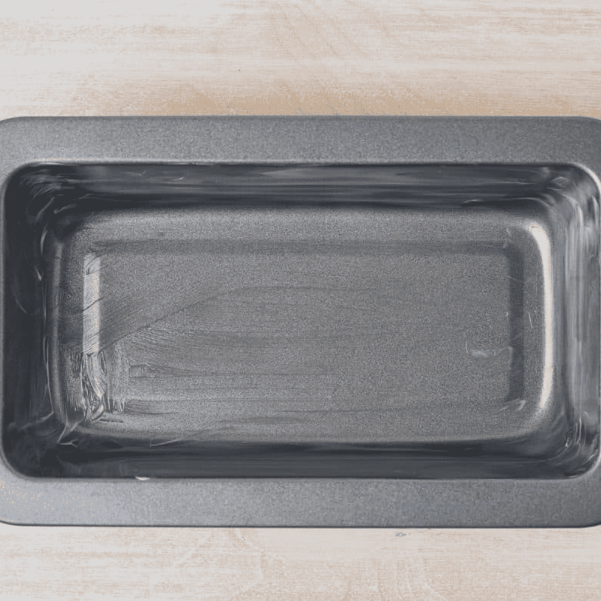 Greased baking pan on counter.