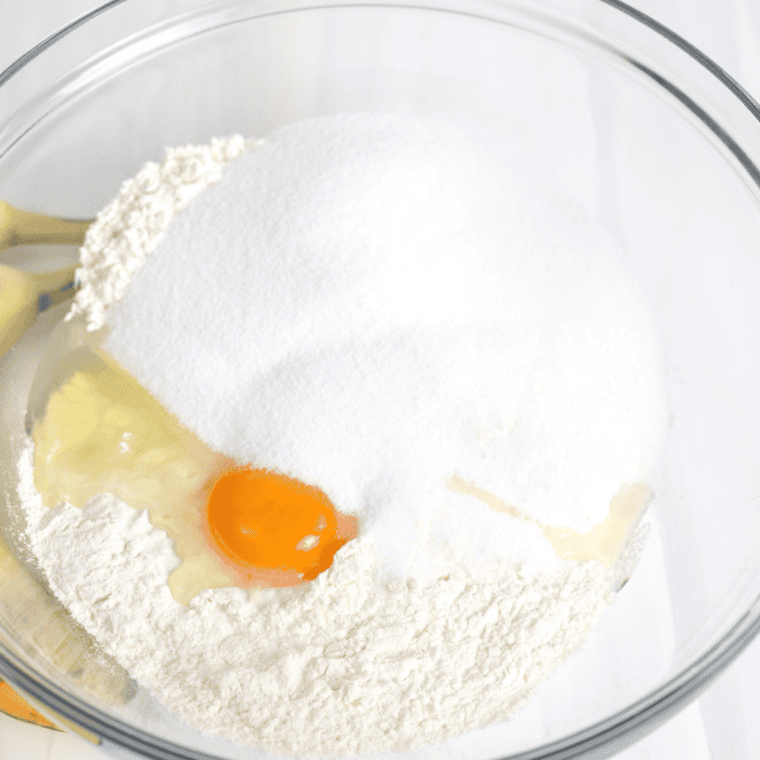 Mixing sugar, butter, pumpkin puree, eggs, and vanilla in a large bowl.