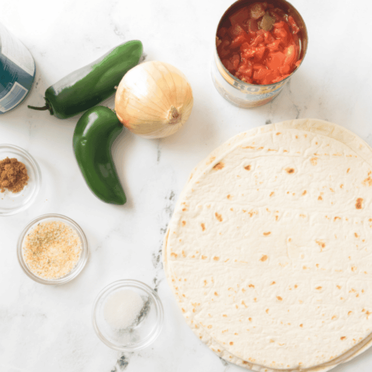 Cutting corn tortillas into triangle chips, tossing with olive oil and salt in a bowl for even coating before baking or crisping.