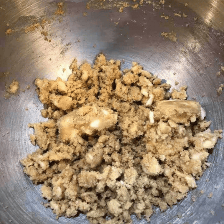 Butter and brown sugar creamed together in a glass mixing bowl