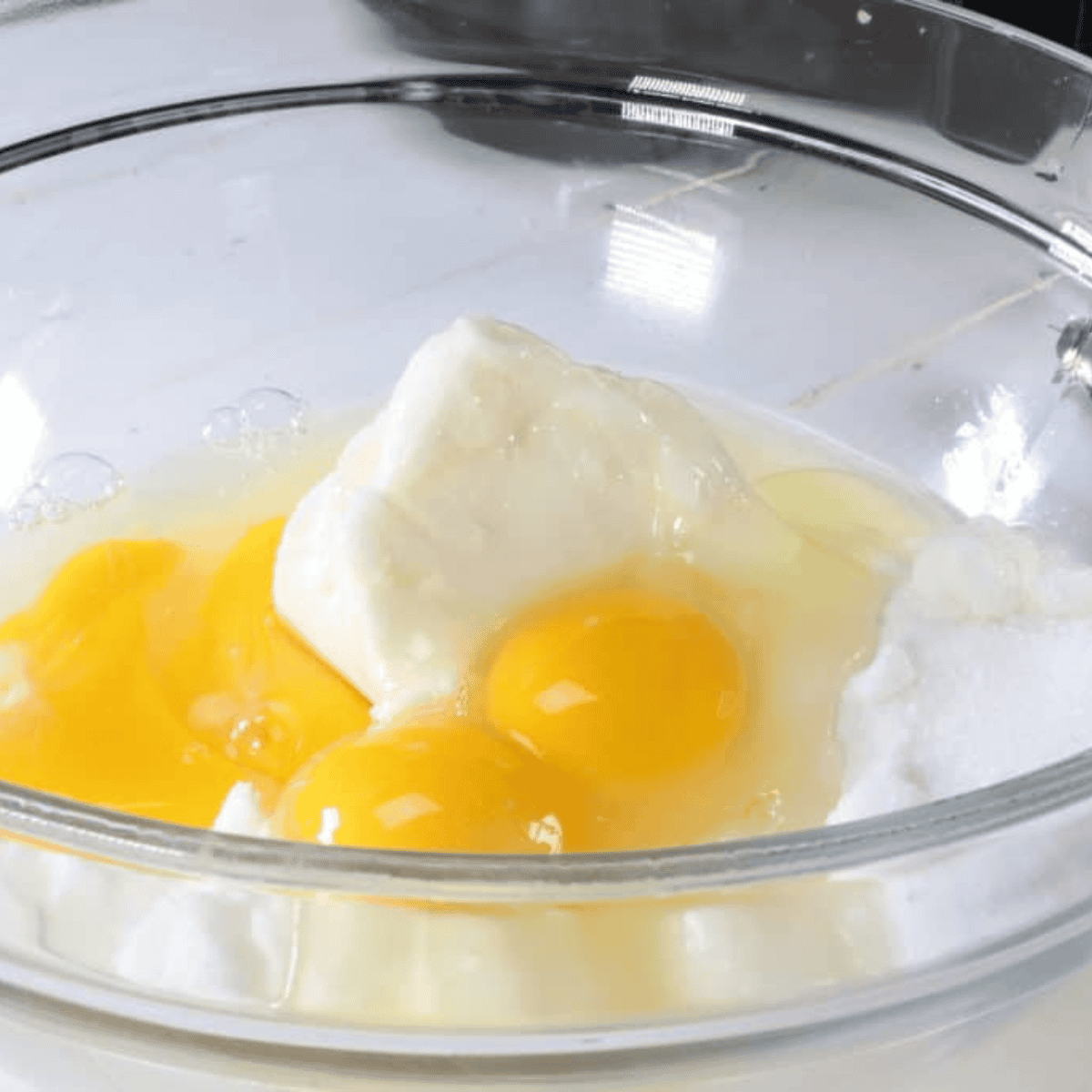 Grease loaf pan and mix brown sugar, cinnamon, and nutmeg in a small bowl; peel, core, and slice apples, tossing with sugar.