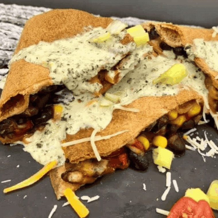 Golden air fryer quesadilla filled with black beans, corn, roasted red peppers, and melted cheese