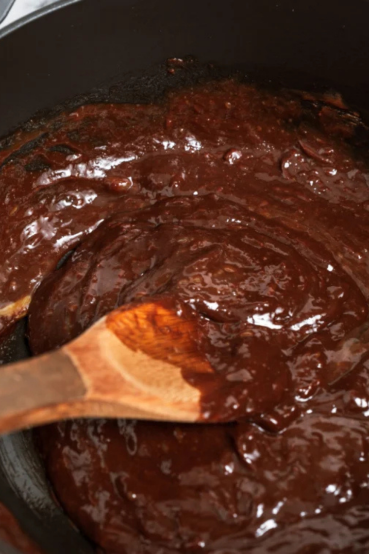 sifting flour cocoa powder and salt into brownie batter before folding gently