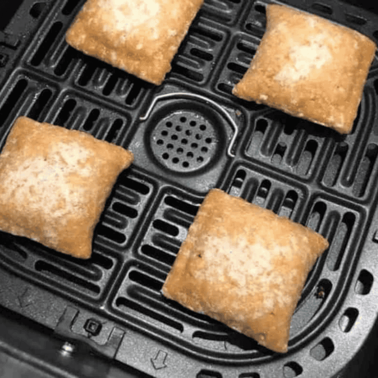Entenmann's cherry pies arranged in a single layer in the air fryer basket