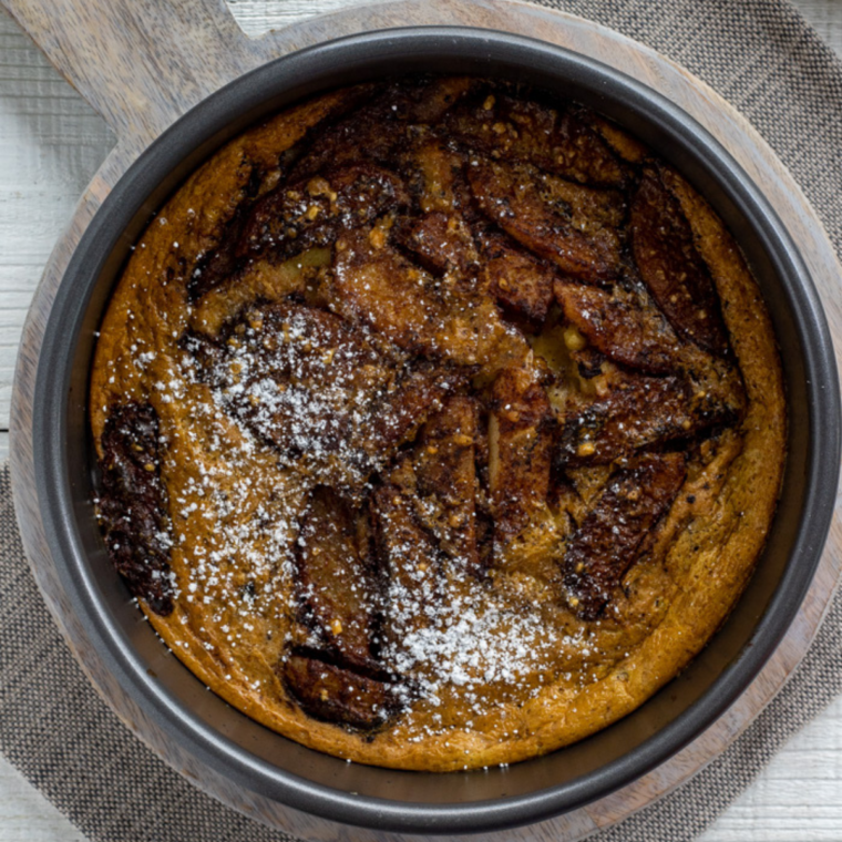 Golden puffed German apple pancake baked in air fryer with cinnamon apples and powdered sugar dusting
