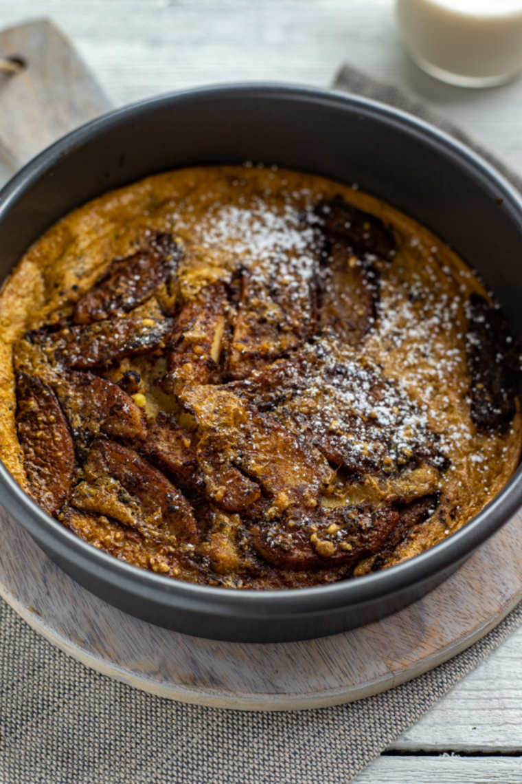 Golden air fryer apple pancake rising with apples baked into the center