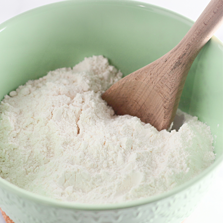 Mixing egg whites, sugar, flour, cream of tartar, vanilla, and salt in a large bowl.
