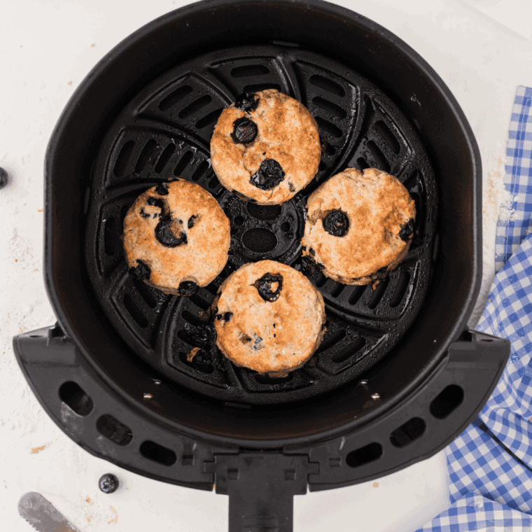 Cooked Blueberry Biscuits in the air fryer basket.