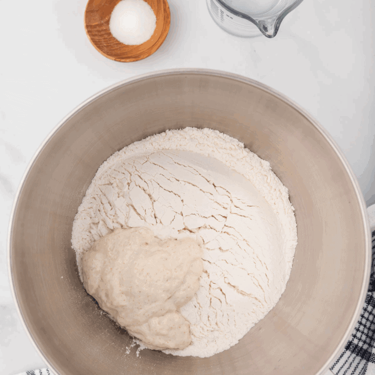 Mixing bowl with flour, sugar, baking powder, Italian seasoning, garlic powder, and salt combined for quick bread