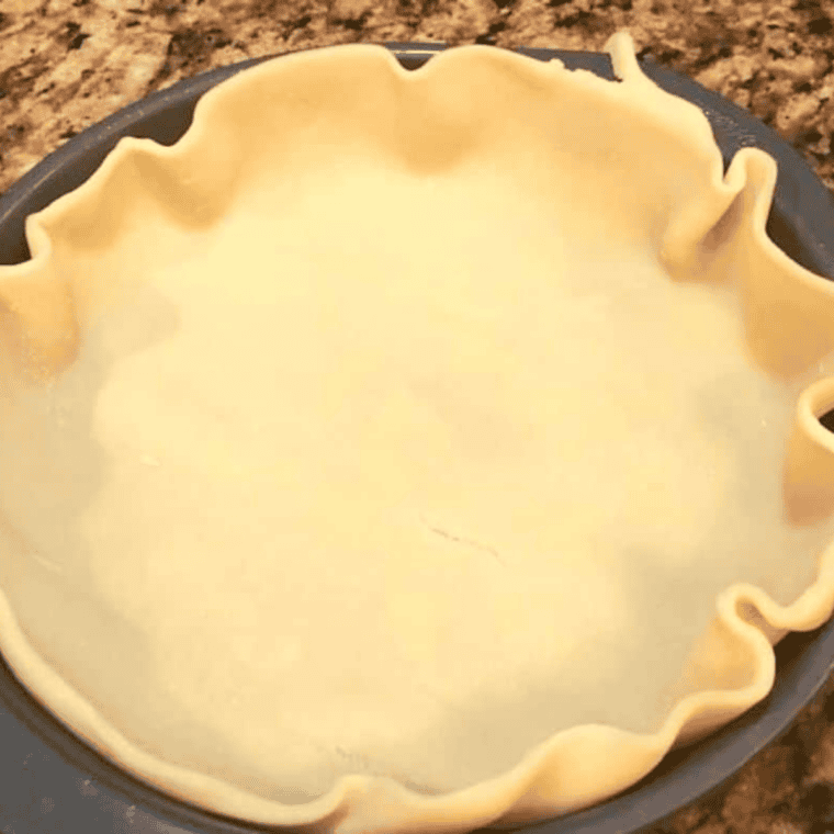 Air fryer dough with peach filling being folded and sealed by hand