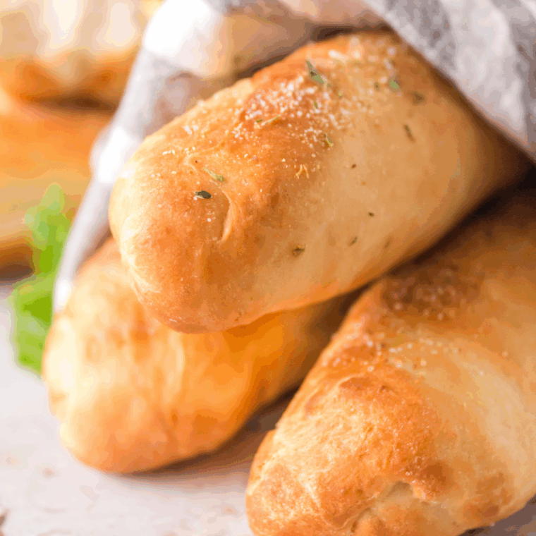 Plate of golden, soft, buttery homemade Captain D’s-style breadsticks, ready to serve.