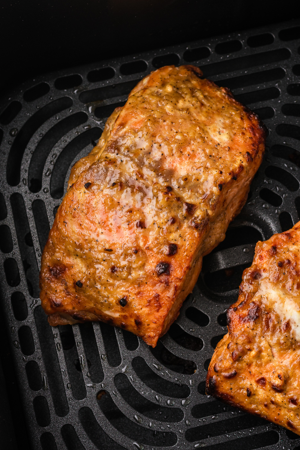 Air fryer frozen salmon cooked directly from frozen producing flaky tender texture with lightly crisp edges in 16 minutes for a quick simple meal