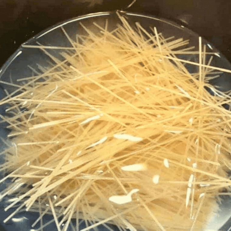 Dry Pasta Roni noodles, 2 cups water, and 2 tablespoons of butter added to the Instant Pot inner pot before pressure cooking