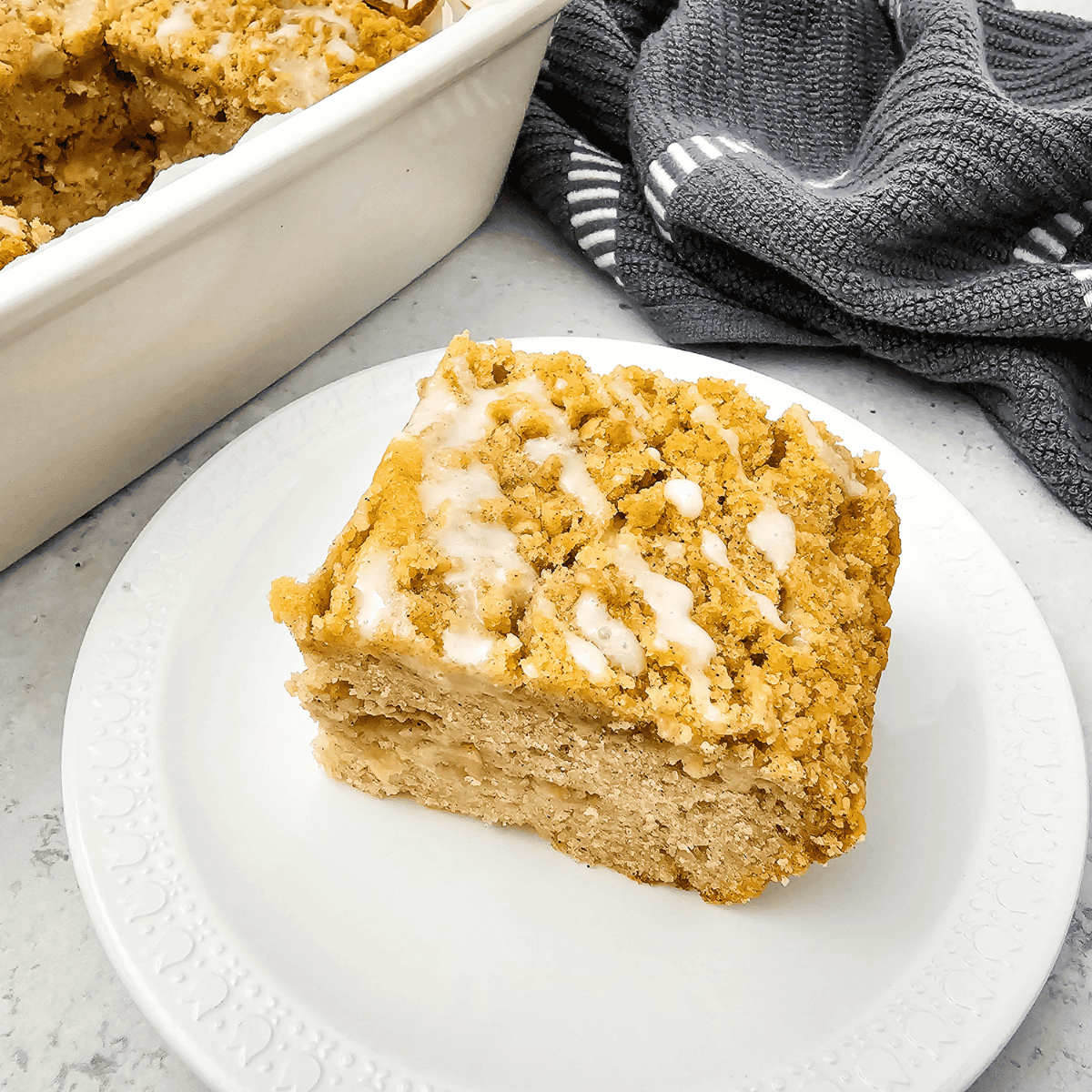 Golden Air Fryer Apple Coffee Cake topped with cinnamon sugar and fresh apple slices.