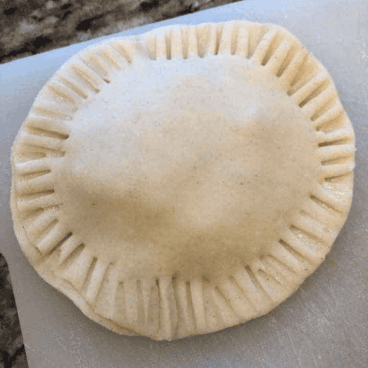 Flaky apple hand pie cooling on a wire rack after air frying