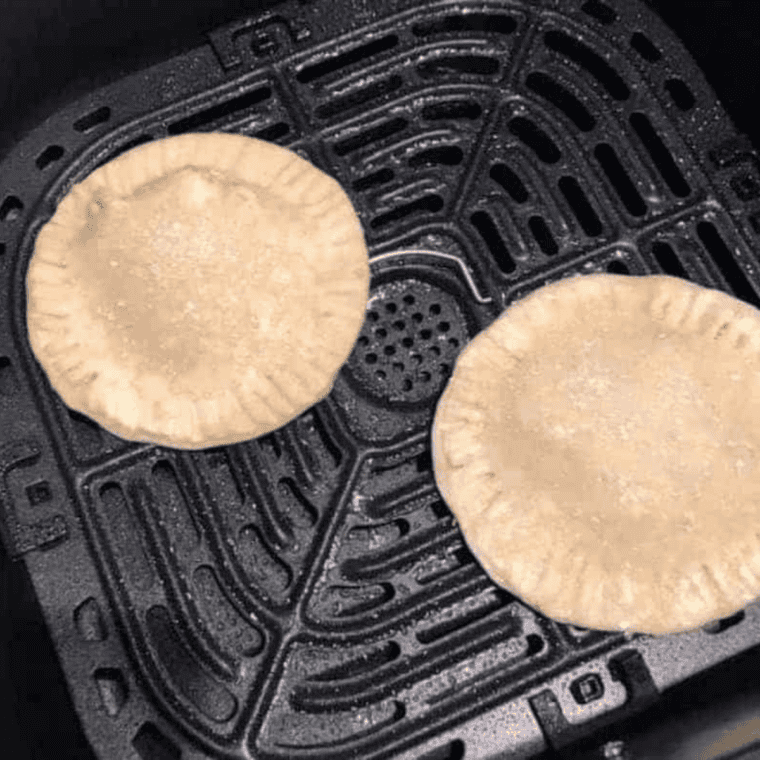 Apple hand pies arranged in a single layer in the air fryer basket