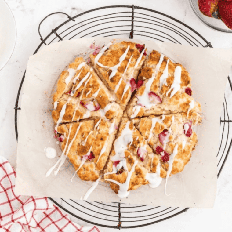 Golden-brown Air Fryer Cherry Scones with juicy cherry pieces, served on a plate.