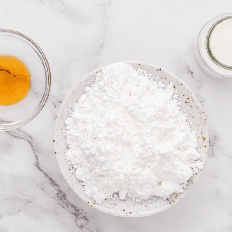 Large bowl with flour, sugar, baking powder, salt, and cut butter being mixed into a crumbly dough.