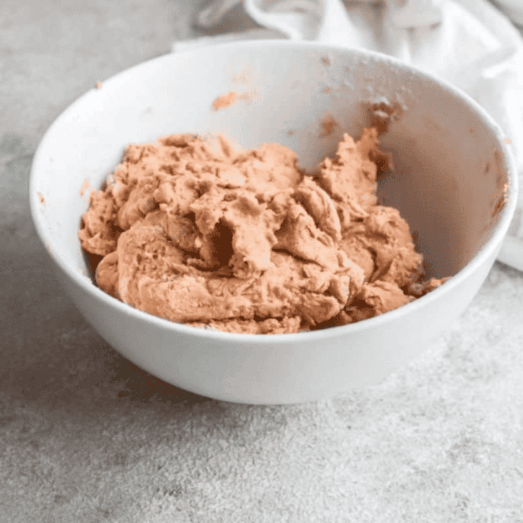 Scone dough placed in a pan, sprayed with olive oil, ready to shape.