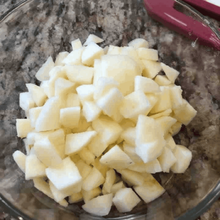 Add diced apples to a large mixing bowl.