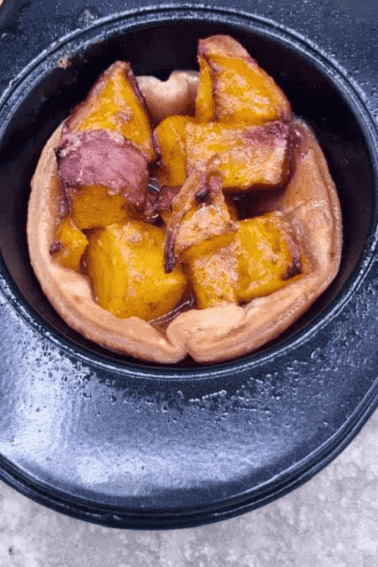Air fryer peach pies served with whipped cream, vanilla ice cream, and caramel drizzle.