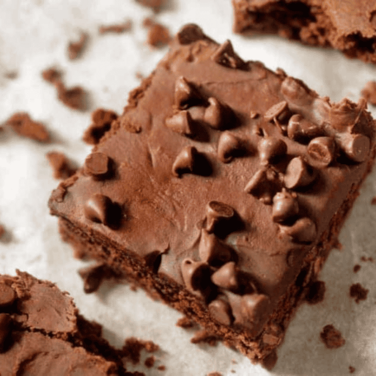 Small batch air fryer brownies cut into fudgy squares with crackly tops and gooey centers stacked on a cooling rack.