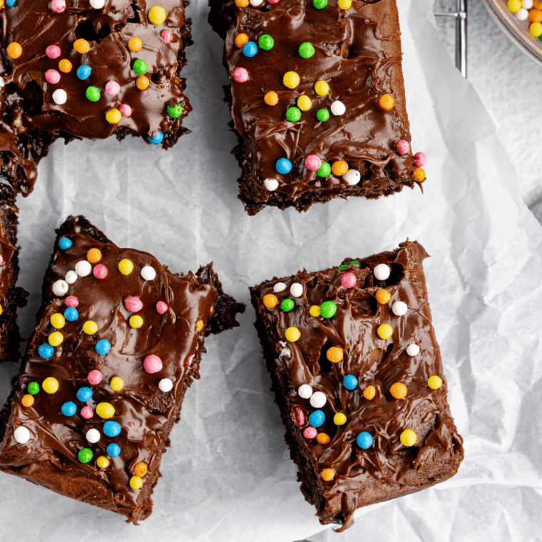 Small batch air fryer brownies cut into fudgy squares with crackly tops and gooey centers stacked on a cooling rack.