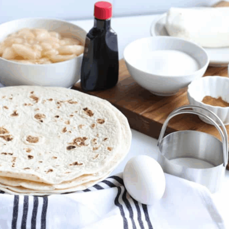 Ingredients needed for Air Fryer Apple Pie Cheesecake Tacos on kitchen table.