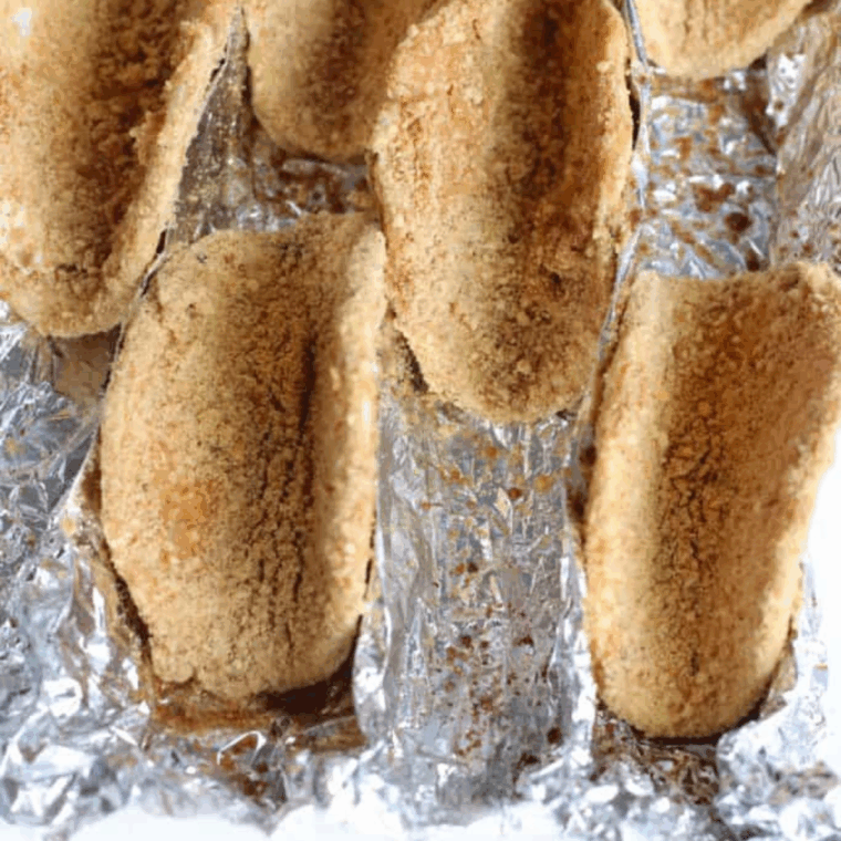 Tortilla circle dipped in egg and graham cracker mixture, then folded into taco shell shape.