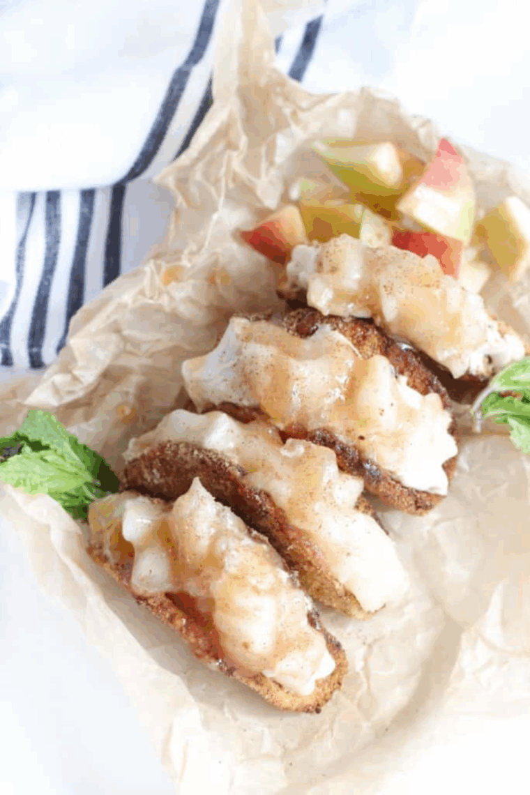 Crispy dessert tacos filled with apple pie filling and creamy cheesecake, served warm.