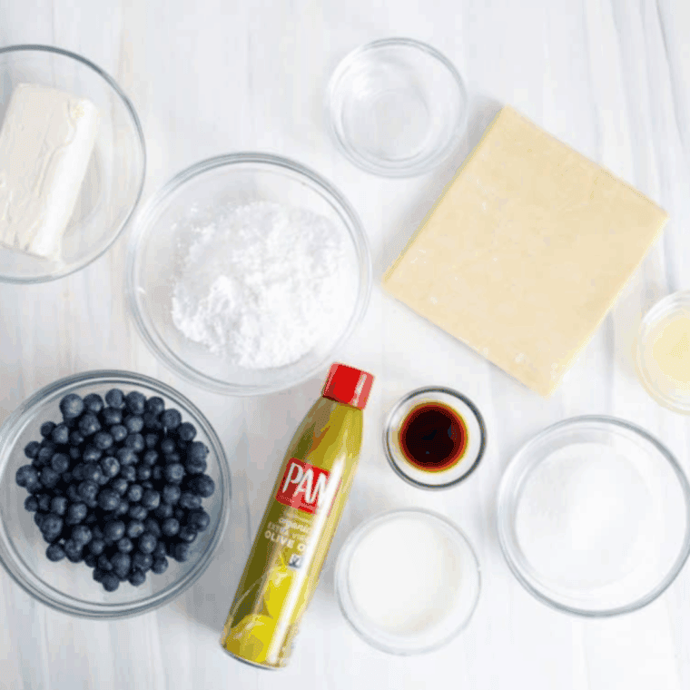 Ingredients needed for Easy Air Fryer Blueberry Cheesecake Egg Rolls on kitchen table.