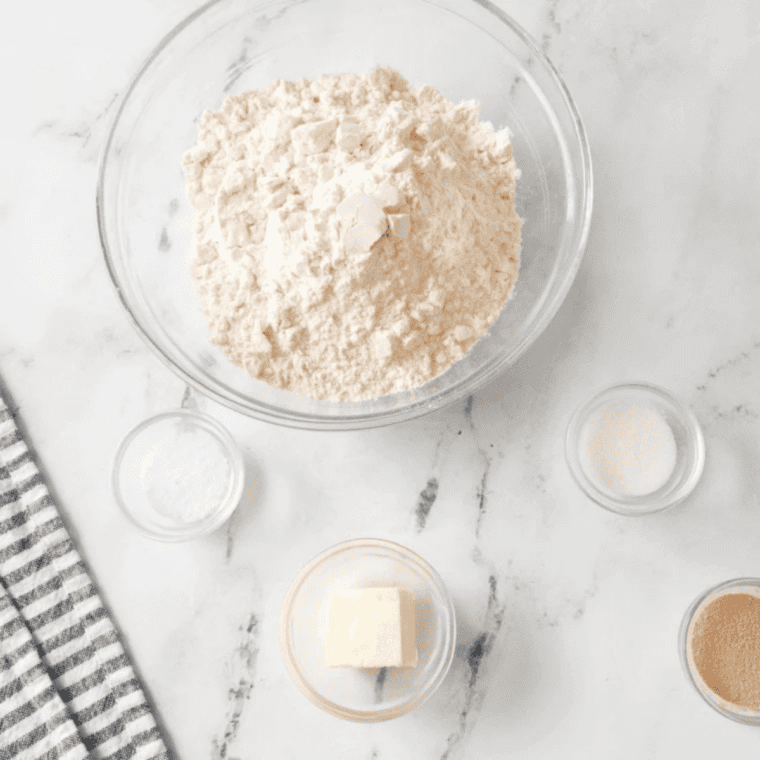 Ingredients for air fryer butter swim biscuits: flour, baking powder, sugar, salt, buttermilk, and butter