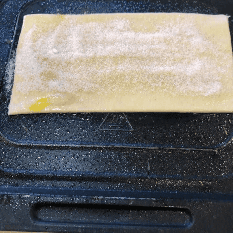 Cinnamon and granulated sugar mixed together in a small white bowl