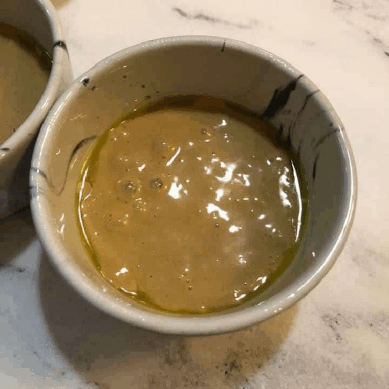 Pouring cookie butter cake batter into ramekins about two-thirds full