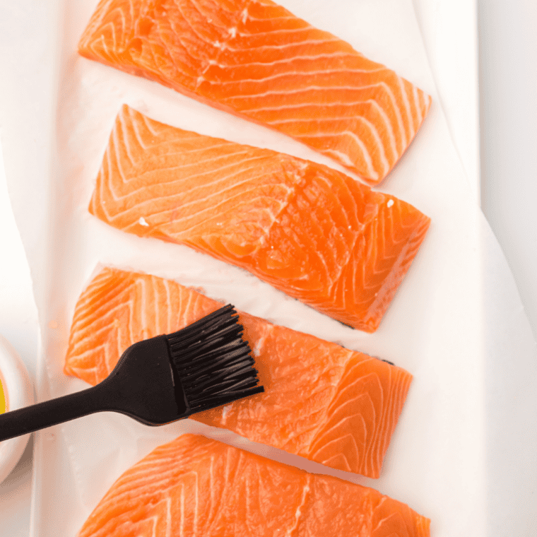 Whisking olive oil, garlic, Dijon mustard, lemon juice, and thyme into lemon Dijon sauce for air fryer salmon